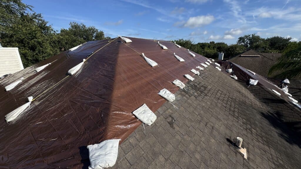 Emergency roof repair Jacksonville FL after storm damage with tarp on roof